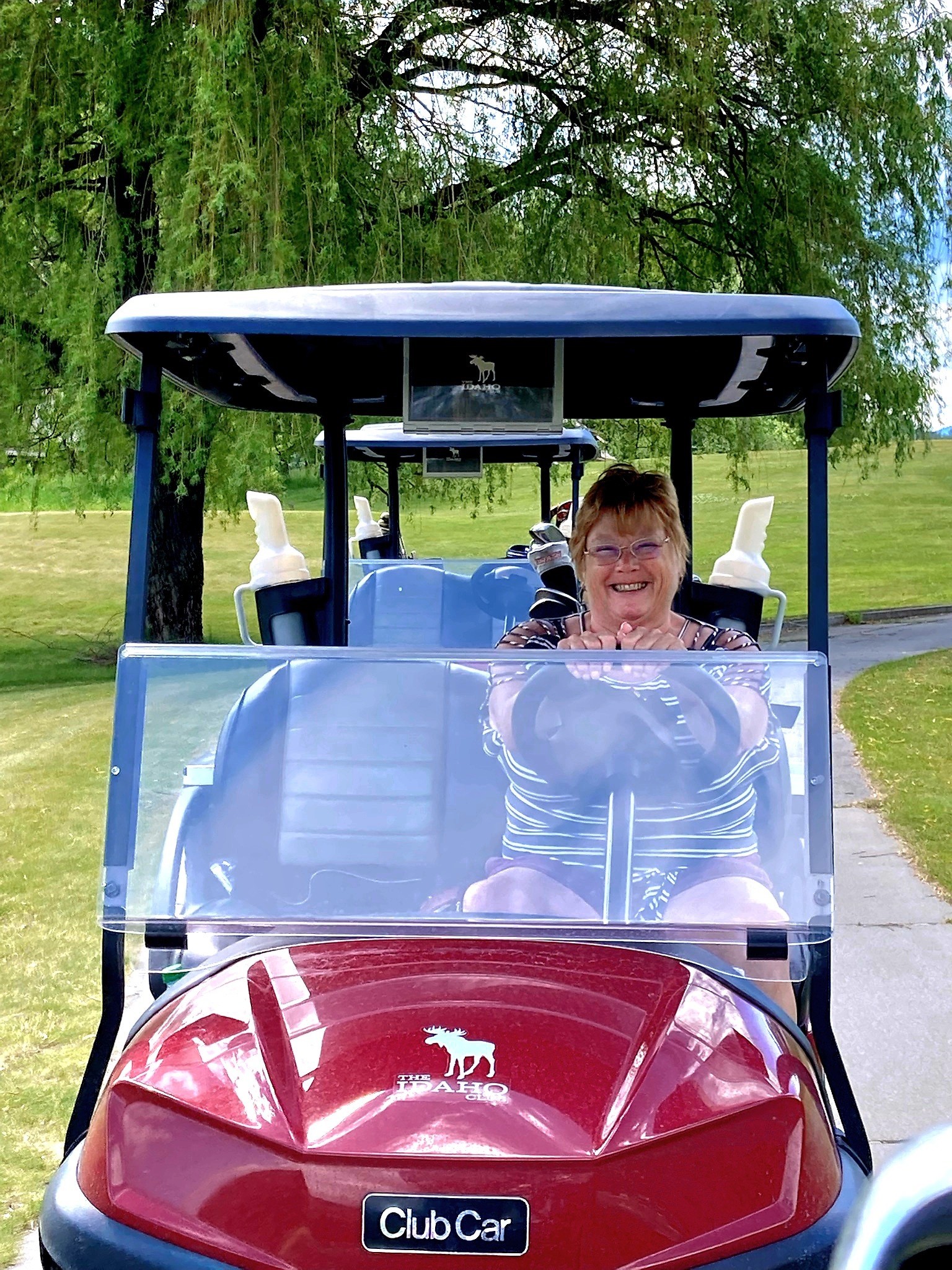 Anne Nelson on a golf cart